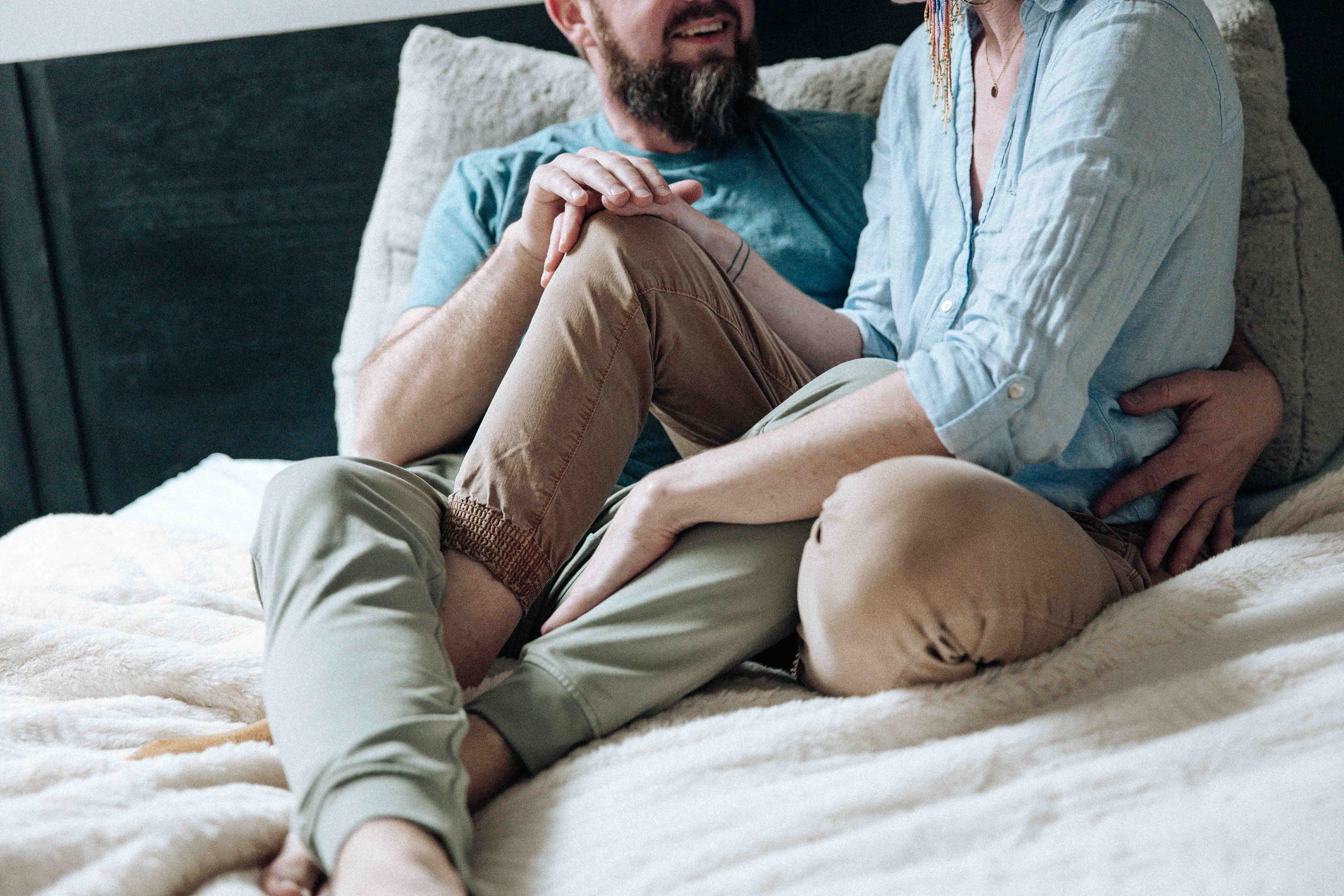 Two people sitting together in a warm, restful embrace